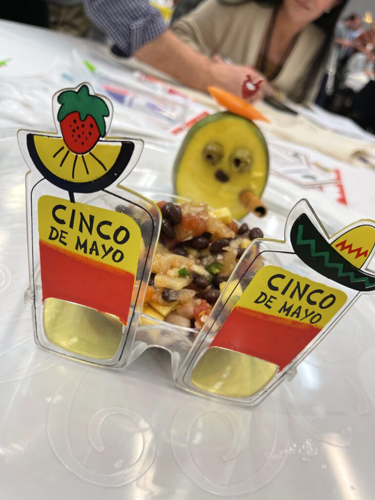 A Cinco de Mayo-themed dish with a creative presentation featuring glasses decorated with fruit and a playful garnish, showcasing the fun and festive atmosphere of the Salsa Showdown team building event.